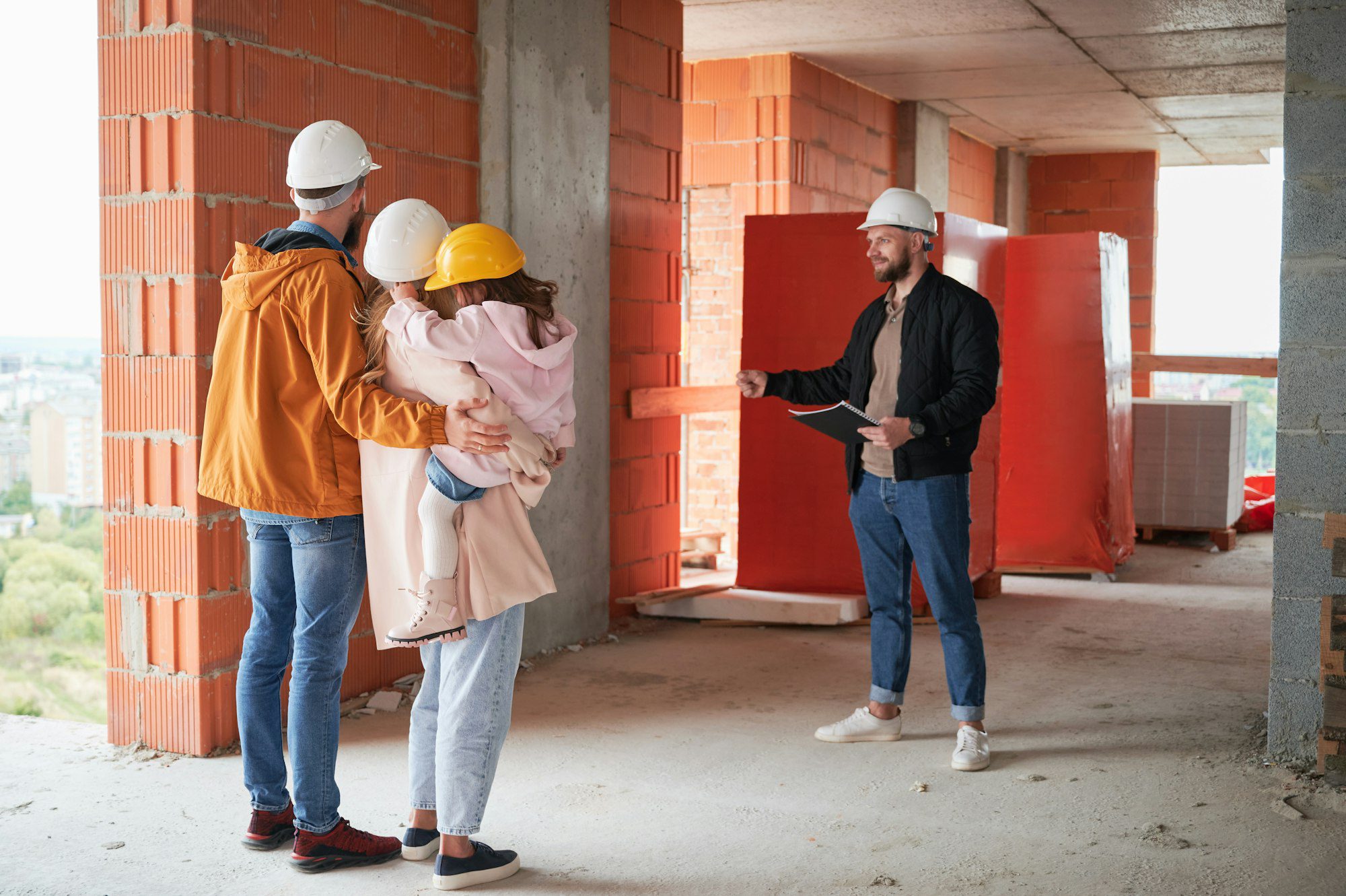 family talking with builder at construction site